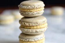 cropped image of a stack of three macarons with a luscious ganache filling in each