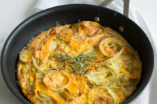 cropped image of a freshly baked Butternut Squash Frittata in a wok, topped with fragrant rosemary