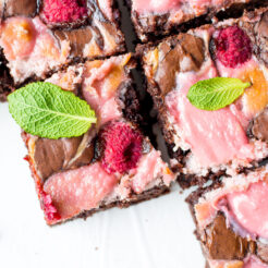 close up image of a cut rapsberry cheesecake brownies
