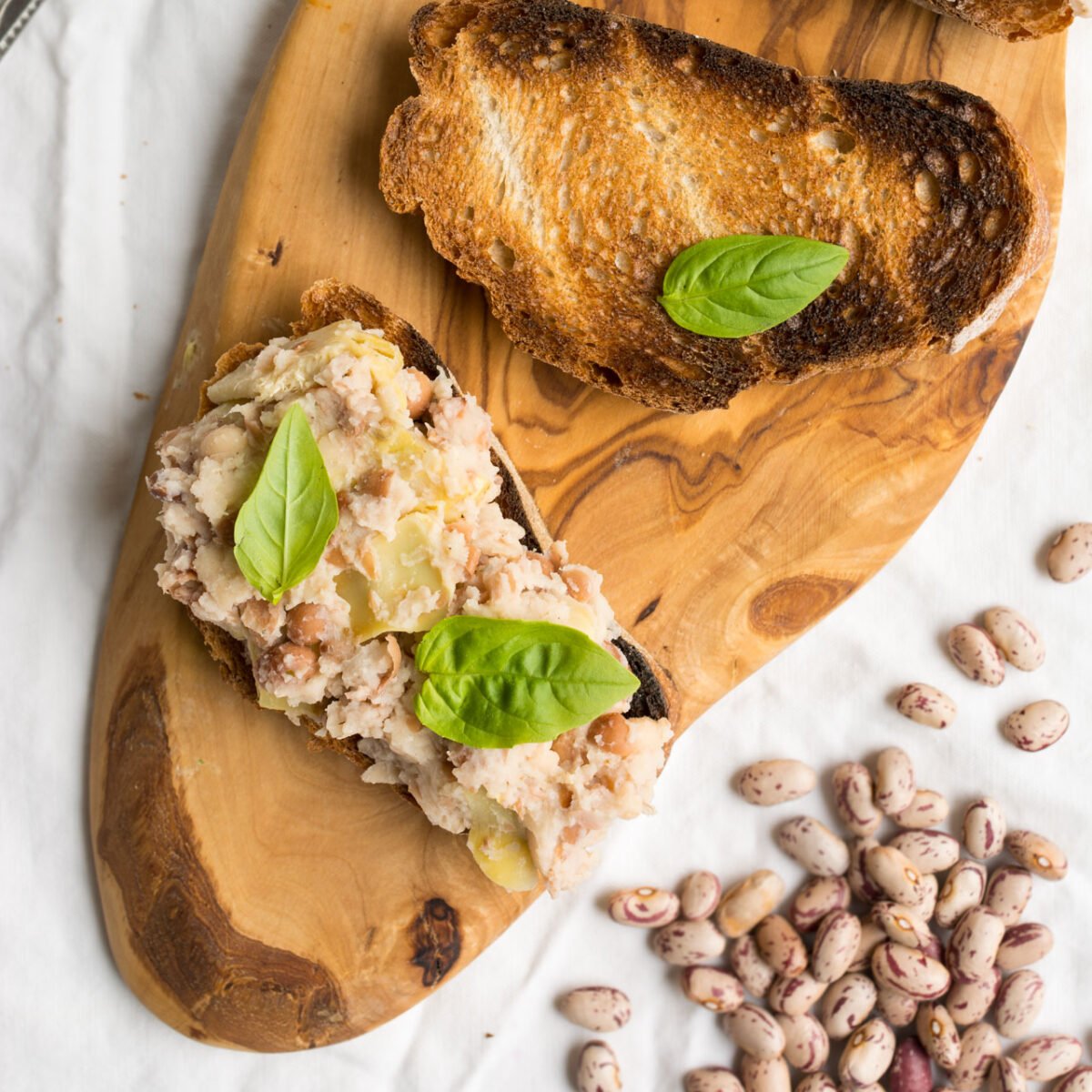 This Super Quick Two Bean and Artichoke Toast is a great lunch or snack when you need something non fussy but delicious. The rich flavour of the beans and the saltiness of the artichoke are perfect for one another topped on a crispy toast!