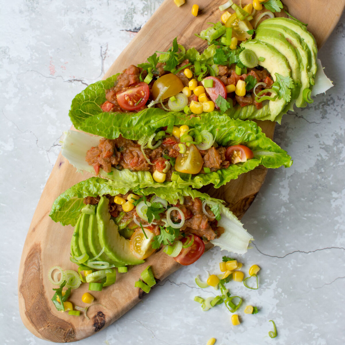 Refried Bean Lettuce wraps, perfect for a vegan lunch on the go, or just a lighter dinner option! Get this super easy recipe here!