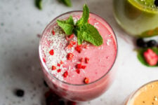A raspberry smoothie garnished with mint.