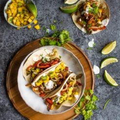 These vegan bean tacos only take one tray and are served with the freshest, zingiest mango salsa!