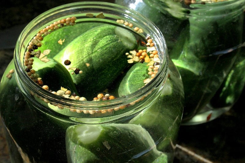Pickles in a large glass jar.