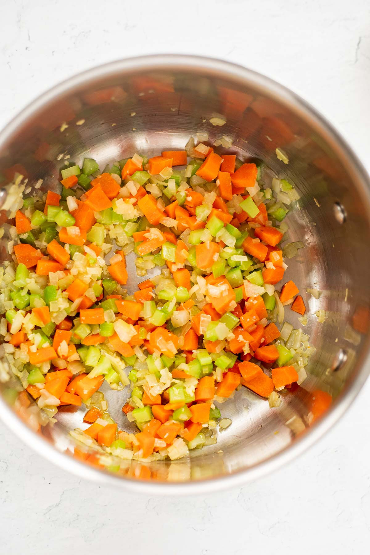 Carrots, onions, and celery in a stock pot.