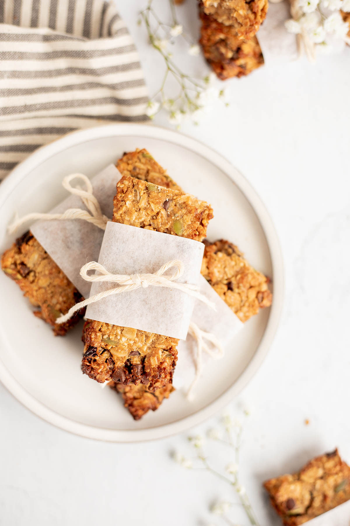 Homemake protein bars wrapped with parchment paper and string.