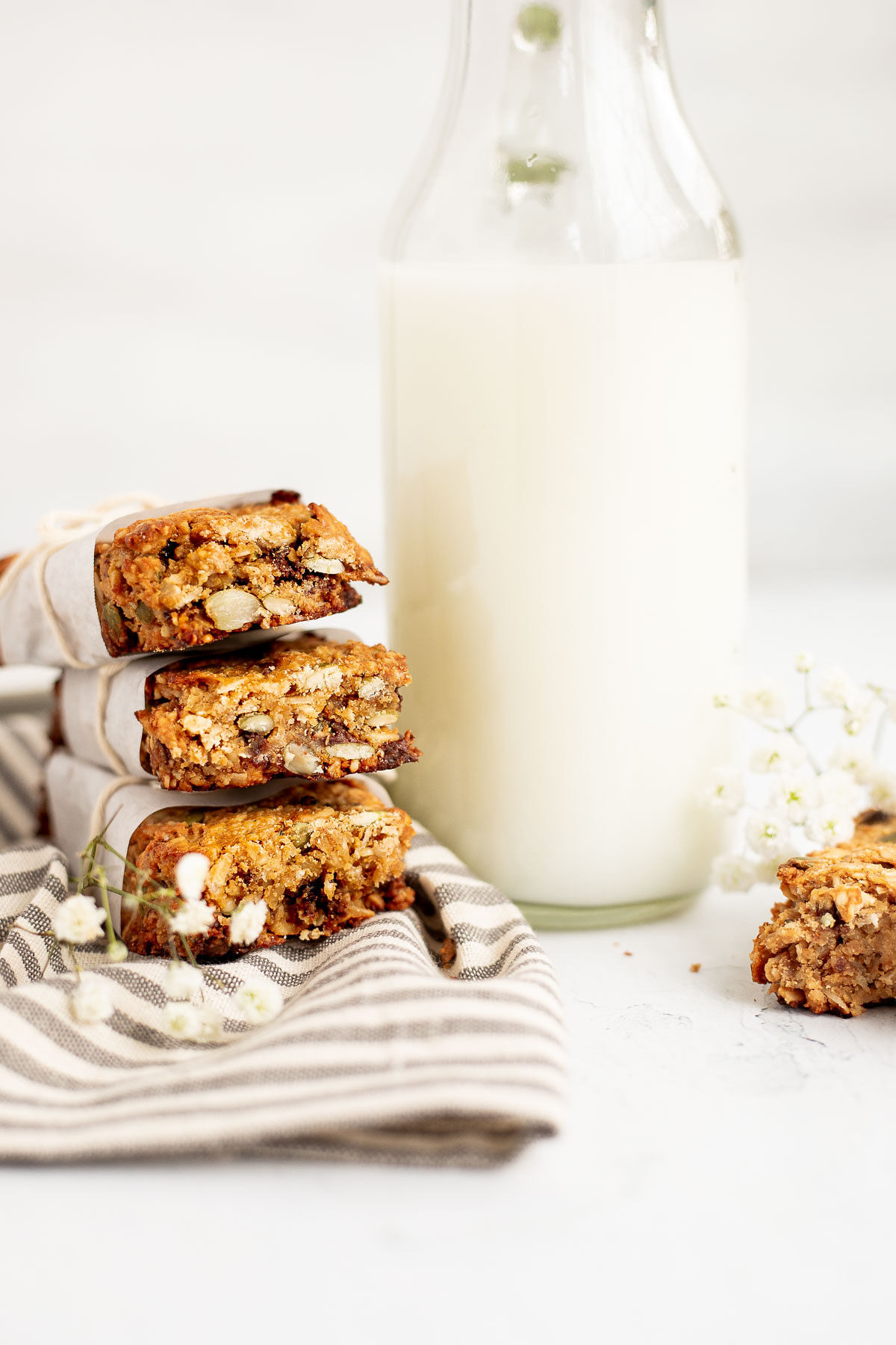 Stacked protein bars with a quart of milk.