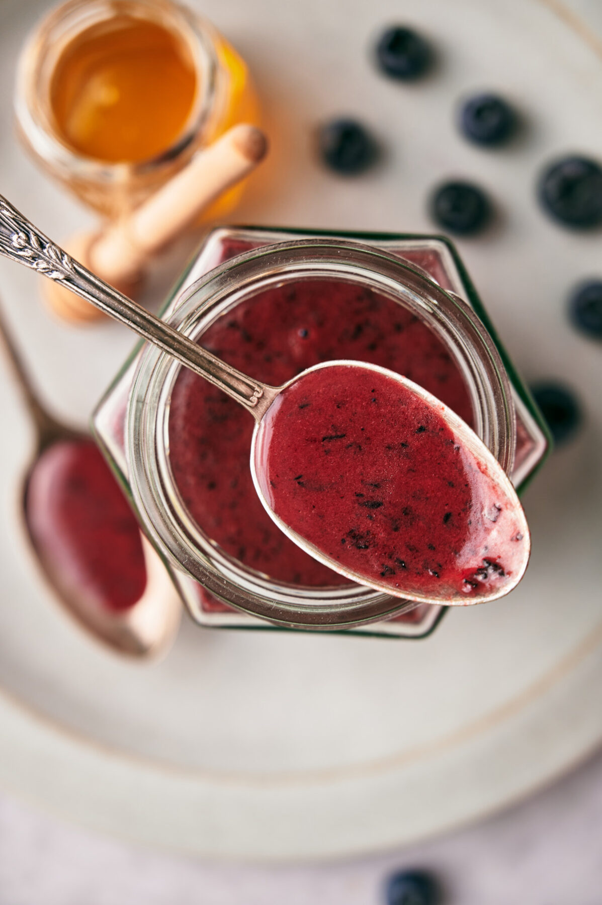 Top view of Blueberry Vinaigrette on a spoon, vertical orientation.