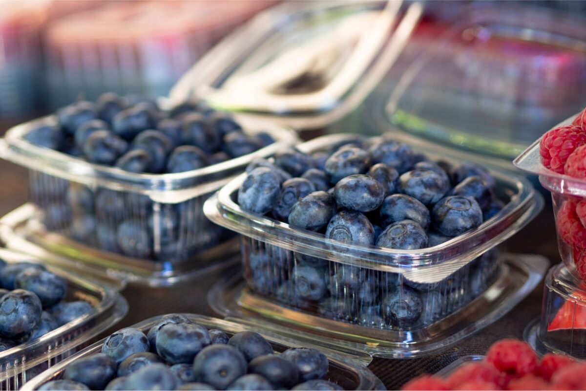 Blueberries in a plastic container at the store.