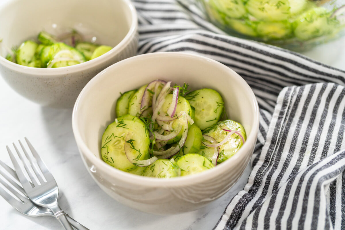 Cucumber salad with red onions, vinegar, and dill.