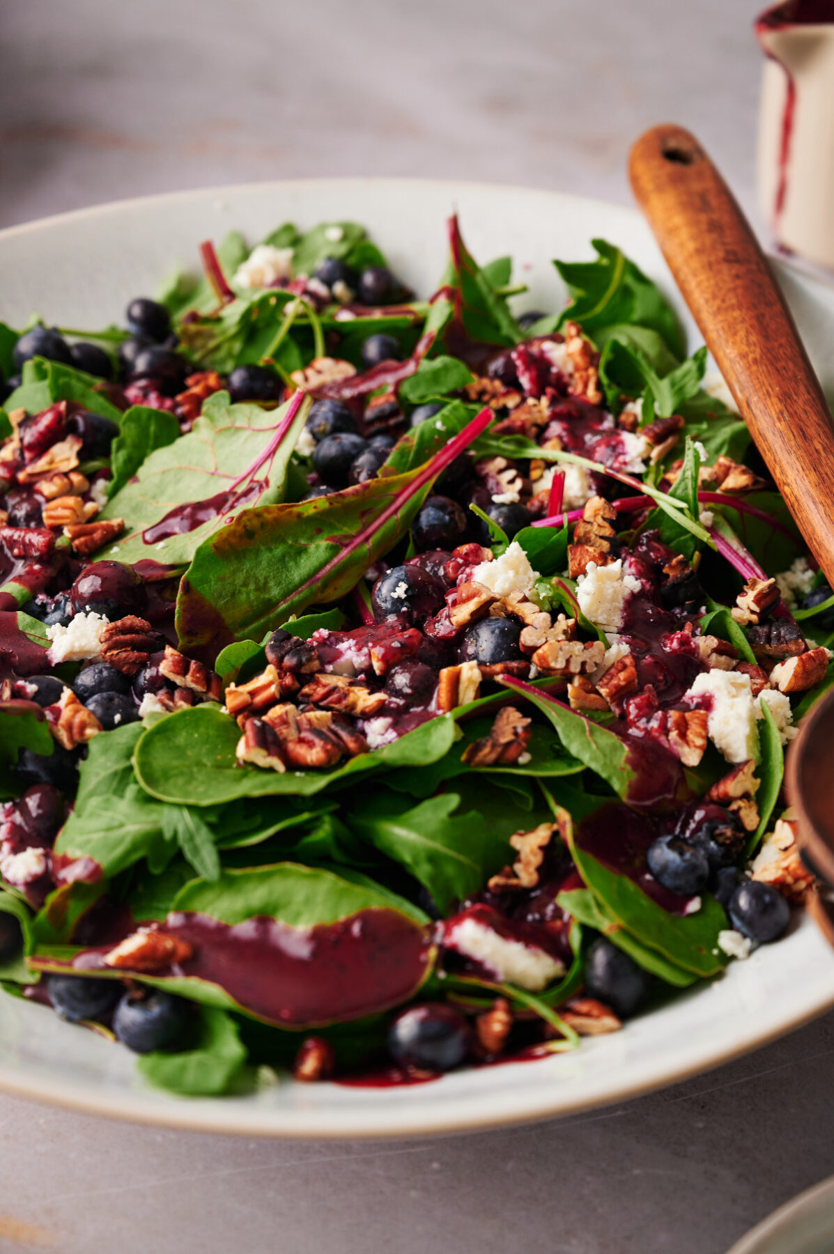 Close-up view of summer blueberry salad with blueberries, feta, and toasted pecans.