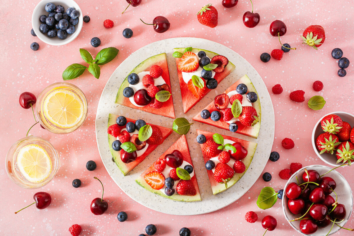 Watermelon pizza slices with yogurt and berries, summer dessert.