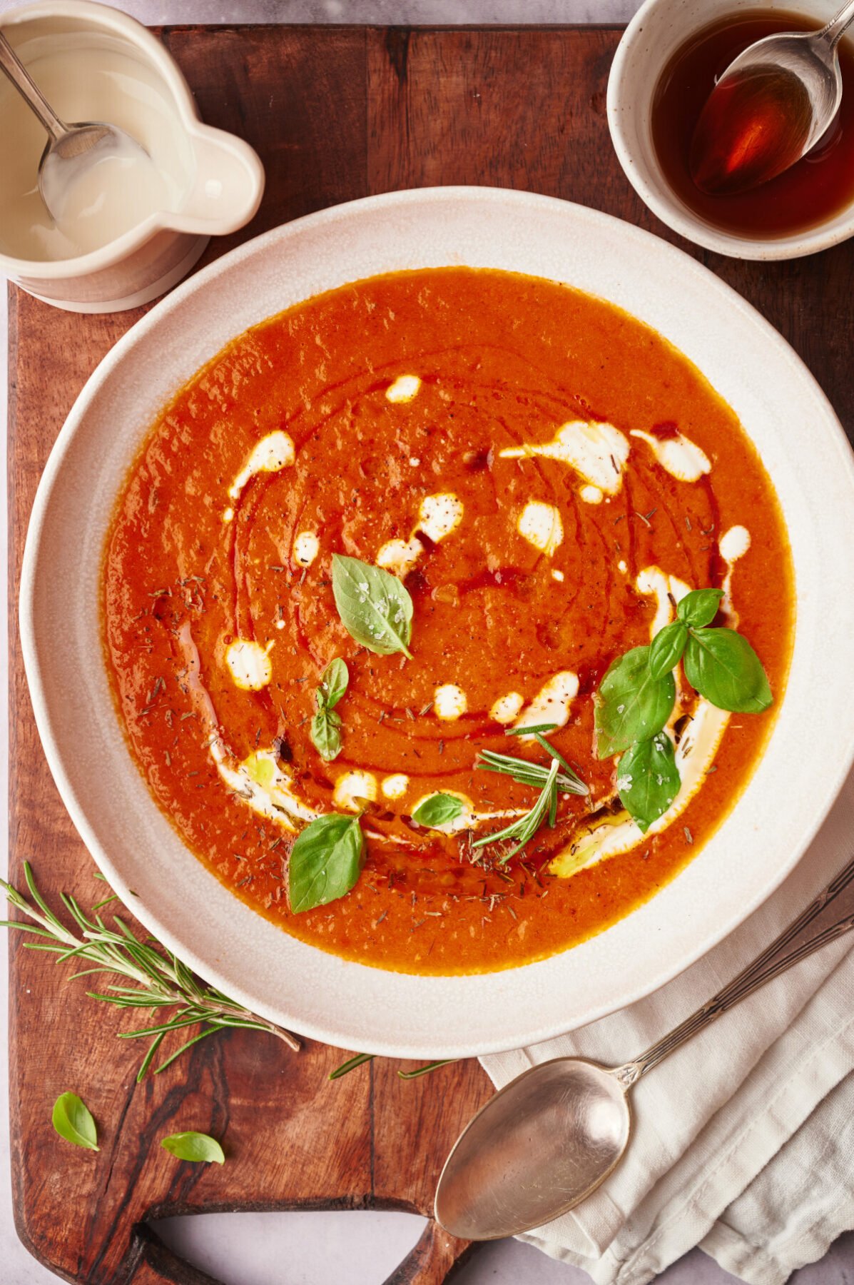 Roasted Tomato Soup in a white bowl with a wooden background.