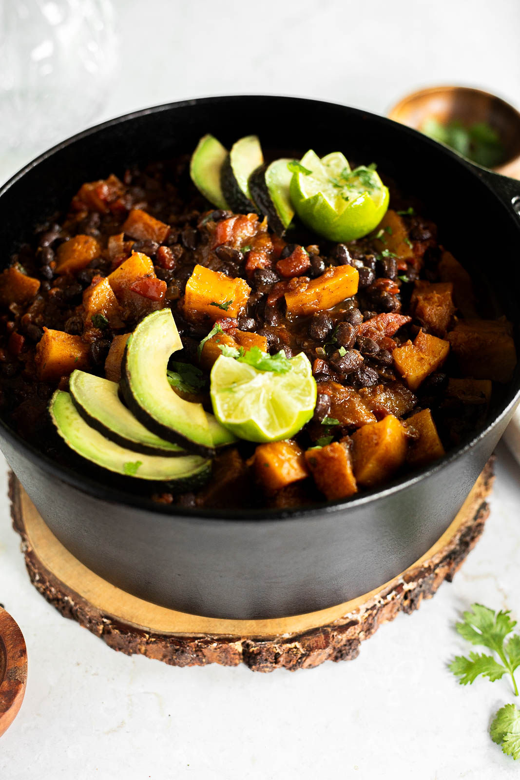Black Bean and Butternut Squash Chili topped with avocado and lime.