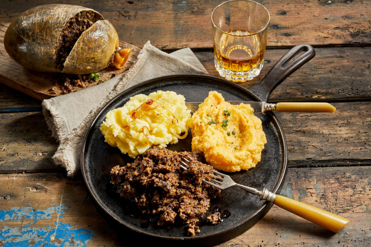 Rustic meal of haggis, neeps and tatties served with a tumbler of whisky to celebrate Robert Burns Supper.