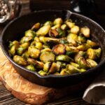 Pan-roasted brussels sprouts in a cast iron skillet.