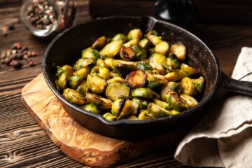 Pan-roasted brussels sprouts in a cast iron skillet.