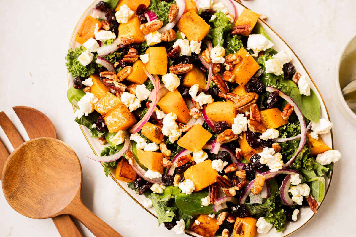 Roasted Butternut Squash Salad on a platter with a salad fork and spoon.