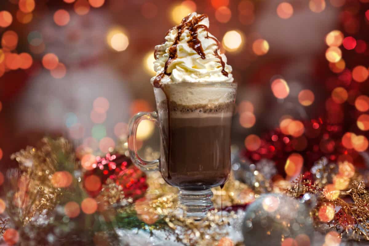 A coffee or chocolate flavored drink topped with whipped cream and chocolate.