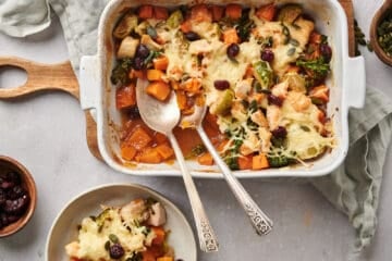 Harvest Chicken Casserole being served with two spoons into a shallow dish.