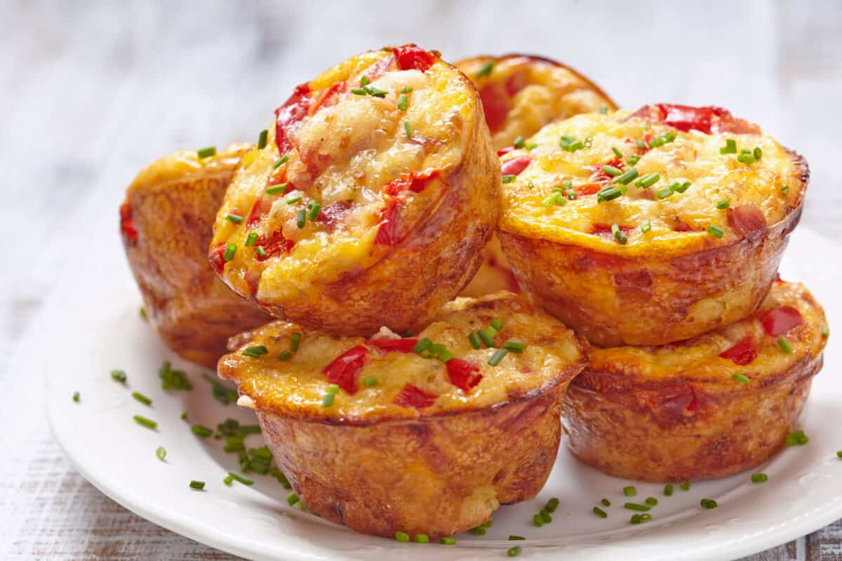 Delicious egg muffins (baked egg cups) with ham, cheese and vegetables.